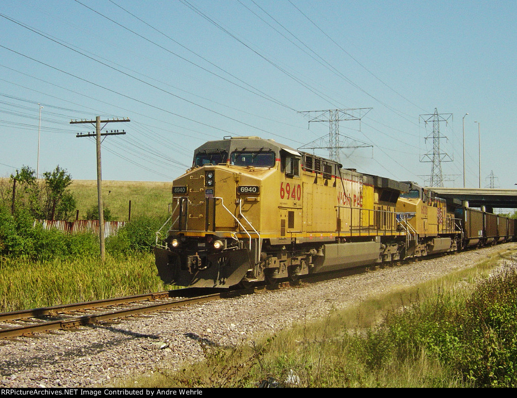 UP 6940 has just passed under Highway 145 and is approaching Fonda Siding